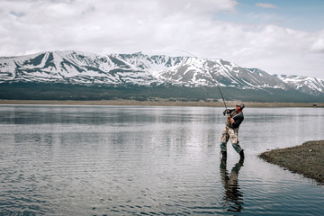 Peaceful fishing at a mountain lakein Mongolia