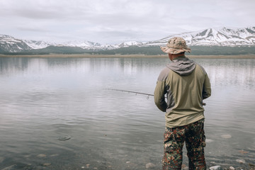 Fishing on the mountain river. Trout fishing. Fisherman fishing in the mountains