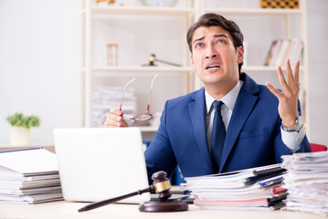 Naklejka premium Young handsome judge working in court