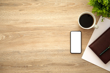 phone with isolated screen on wooden table near notebook coffee