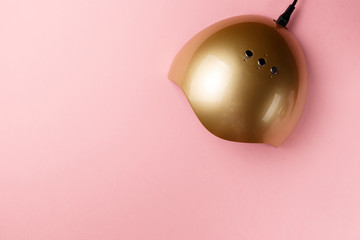 UV lamp lights for nails on pink background. Top view. Flat lay. Copy space. Minimal creative concept. Pink background in pastel colours