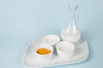 Collage of baking ingredient objects isolated on blue