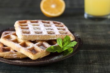 Viennese, Belgian waffles with honey on a white plate.