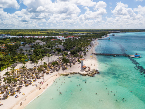 Dominican resort at Caribbean sea with white sand, sunshades  and lighthouse (aerial shot)