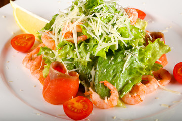 Caesar salad with shrimps and salmon