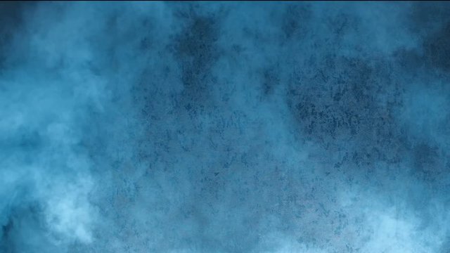 A sharp ejection of a smoky cloud up against a dark blue wall. Concept of explosion or fire. Smoke bomb or gas attack.