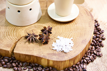 Fototapeta na wymiar Still life with coffe beans and cloves on wooden