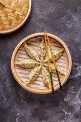 Asian dumplings, soy sauce, chopsticks, top view