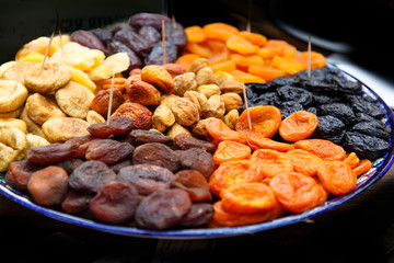 Dried fruits: dried apricots, prunes and others lie on a plate