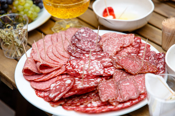 Different types of sausages cut into slices lay on a plate