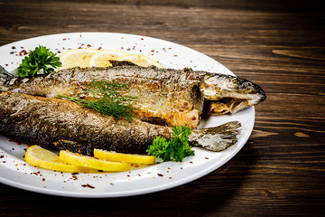 Fish dish - fried fish fillet on wooden table
