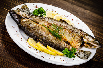 Fish dish - fried fish fillet on wooden table