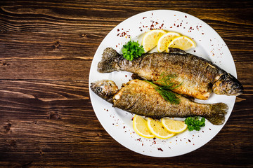Fish dish - fried fish fillet on wooden table