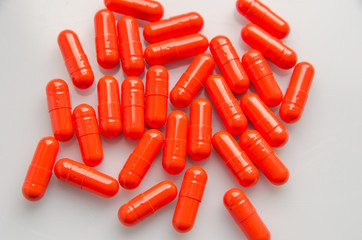 red capsules scattered on the table