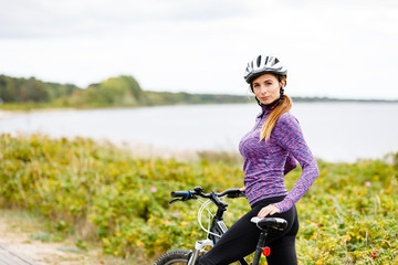 Young woman cycling at seaside