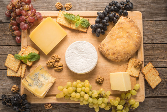  Cheese with grapes, walnuts and cracker on a table 