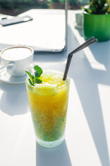 Cocktail glass of mojito with ice on table in cafe