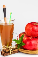 Fresh apple juice in a glass. Fruit harvest. Healthy beverage. Apples on the kitchen table. Production of juice. On a white background.