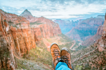Close up of man wearing mountain boots and landscape of mountains