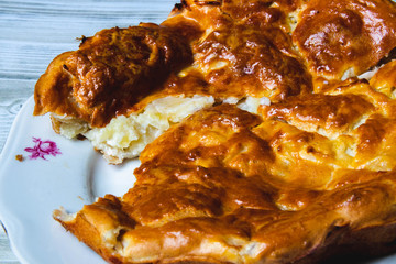 apple pie on a plate. Wooden table. close up.