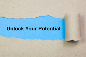 unlock your potential text on paper. Word unlock your potential on torn paper. Concept Image.