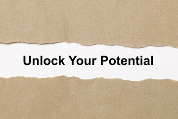 unlock your potential text on paper. Word unlock your potential on torn paper. Concept Image.