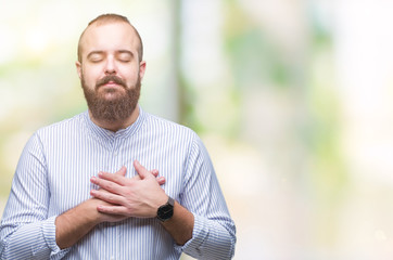Young caucasian hipster man over isolated background smiling with hands on chest with closed eyes and grateful gesture on face. Health concept.