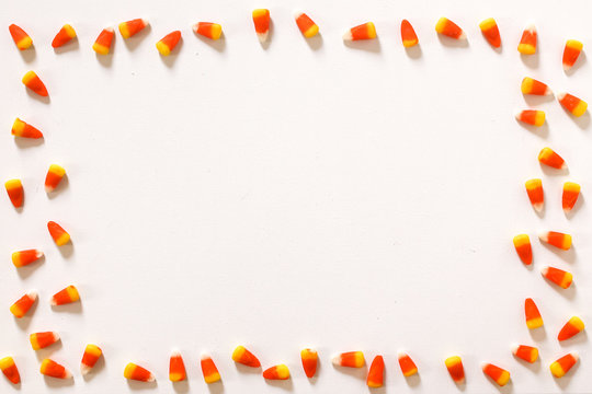 Candy Corn Frame against a white background Top View Flat Lay, Modern Halloween Concept with Copy Space