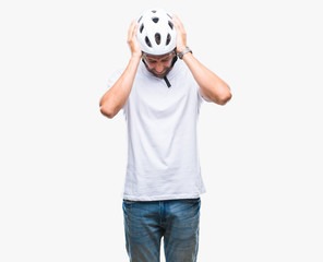 Handsome hispanic cyclist man wearing safety helmet over isolated background suffering from headache desperate and stressed because pain and migraine. Hands on head.