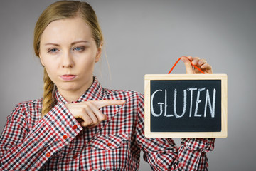 Woman holding board with gluten sign
