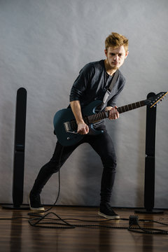 Young man playing electric guitar