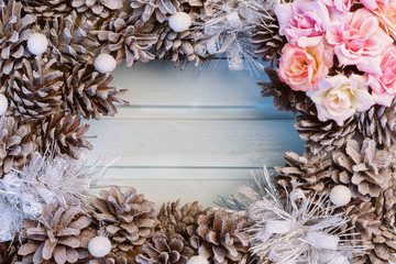 Christmas composition, frame. Spruce cones and flowers. In the center on a blue wooden background, a place for text, copy space.
