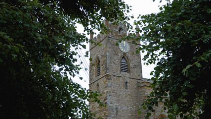 Fototapeta na wymiar peaceful rural church of the holy cross yard in milton malsor uk