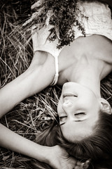 Redhead girl lying down at grass. Image in black and white style © Masson