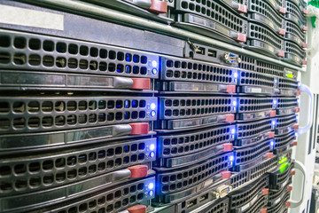 Colocation space for several servers. Hosted services are in the datacenter room.  Modern computer equipment for information processing. Database servers are  close-up