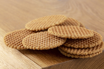 Waffles scattered on a wooden table. Macro. Copy space.