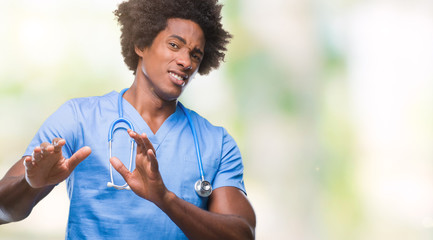 Afro american surgeon doctor man over isolated background disgusted expression, displeased and...