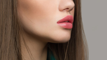 Perfect beauty natural lip makeup. Close up macro photo with beautiful female mouth. Plump full lips. Perfect clean skin, light fresh lip make-up. Beautiful, spa, cosmetology, injection