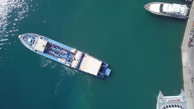 Passenger ferry docking at a Greek island port - One minute top down aerial footage following the procedure.
