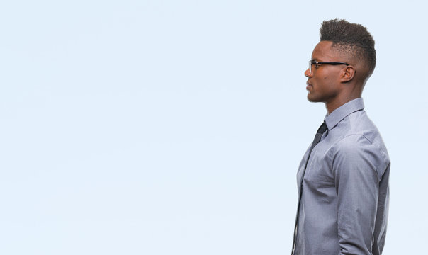 Young African American Business Man Over Isolated Background Looking To Side, Relax Profile Pose With Natural Face With Confident Smile.