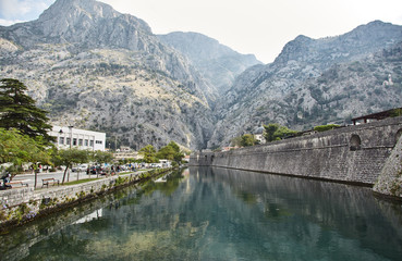 Stone wall and moat with water. Montenegro. The Town Of Kotor. 