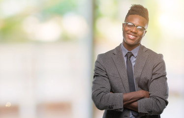 Young african american business man over isolated background happy face smiling with crossed arms looking at the camera. Positive person.