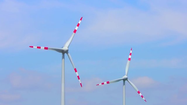  4K footage of wind turbines (aerofoil-powered generators) creating renewable energy. Arrays of large turbines, known as wind farms, are becoming an increasingly important source of renewable energy.