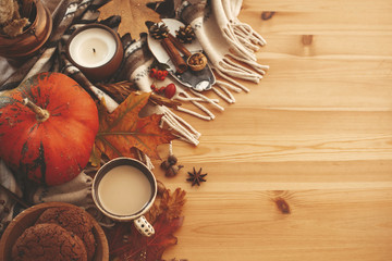 Autumn Flat Lay. Pumpkin,coffee,candle,fall leaves, cookies,berries,nuts,acorns on rustic blanket and wood background top view. Seasons greetings. Space for text. Happy Thanksgiving