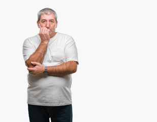 Handsome senior man over isolated background looking stressed and nervous with hands on mouth biting nails. Anxiety problem.