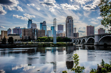Daytime Cityscape skyline of Downtown Minneapolis Minnesota in the Twin Cities Metro area. Reflection in the Mississippi River - obrazy, fototapety, plakaty