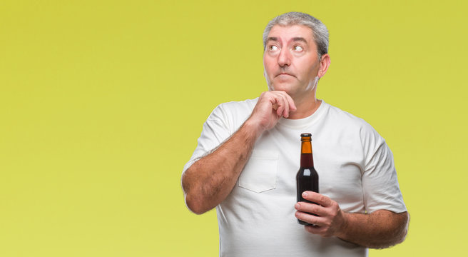 Handsome senior man drinking beer bottle over isolated background serious face thinking about question, very confused idea