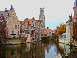 Fototapeta na wymiar Brugge/Belgium - Autumn. Old town buildings on the canal. Beautiful reflection