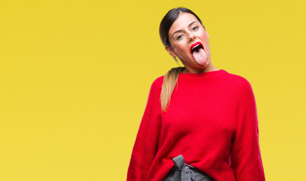 Young beautiful business woman wearing winter sweater over isolated background sticking tongue out happy with funny expression. Emotion concept.
