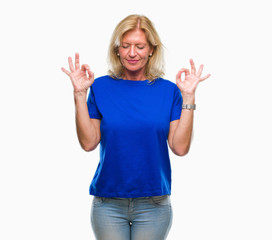 Fototapeta na wymiar Middle age blonde woman over isolated background relax and smiling with eyes closed doing meditation gesture with fingers. Yoga concept.